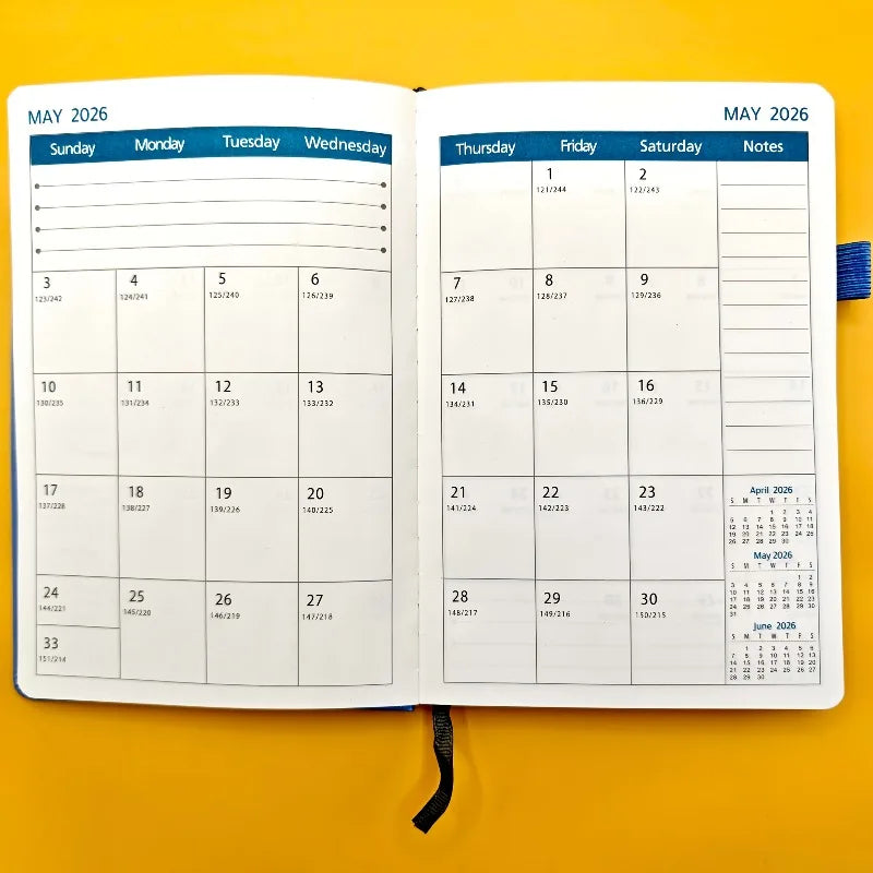 Open planner showing May 2026 calendar on a yellow background