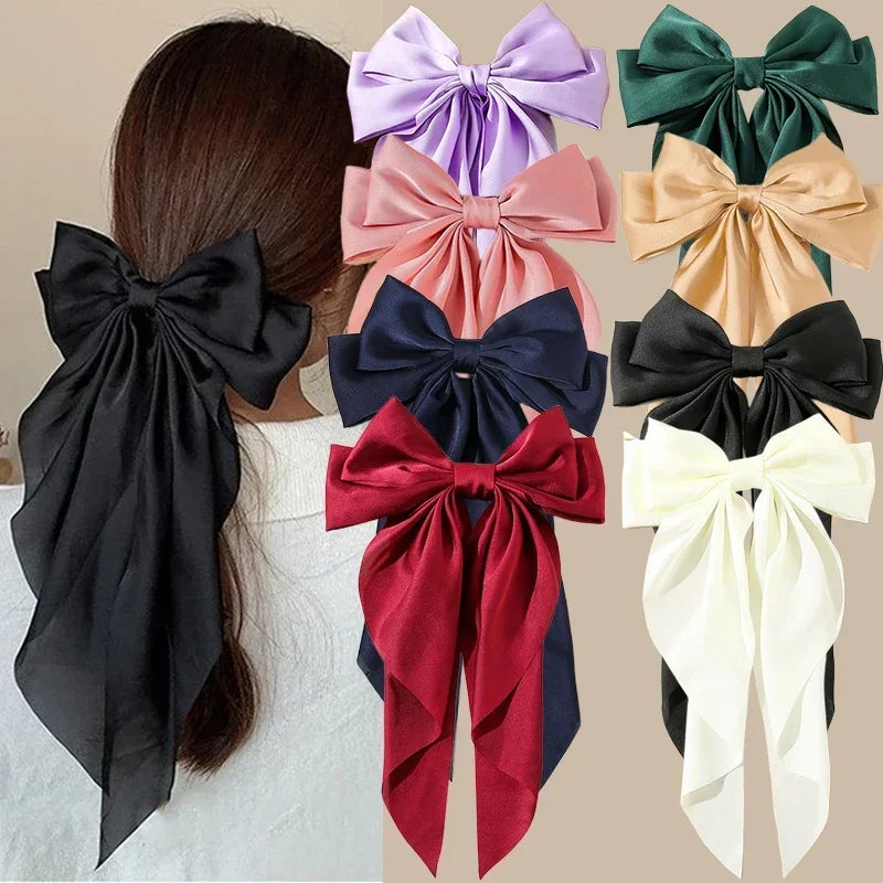 Collection of colorful hair bows displayed on a person's head and arranged separately.