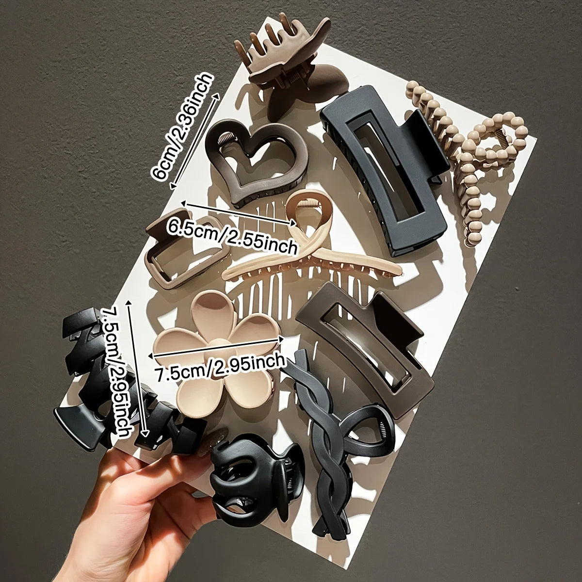 Collection of hair clips with measurements on a white surface