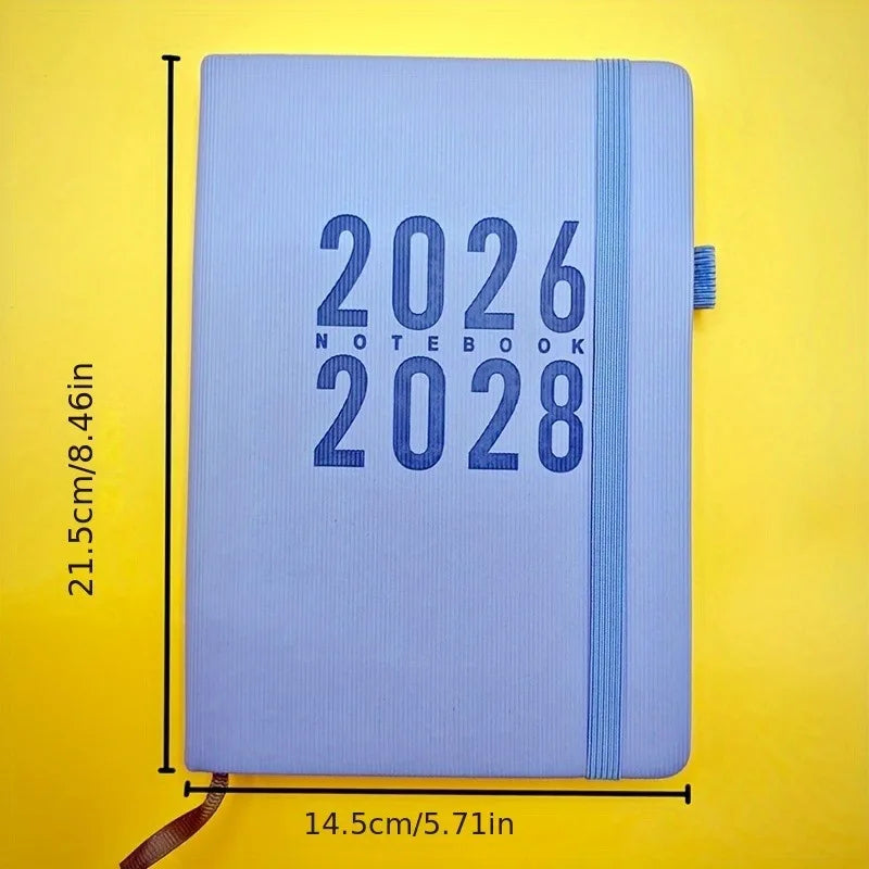 Blue notebook with '2026 Notebook 2028' text on a yellow background