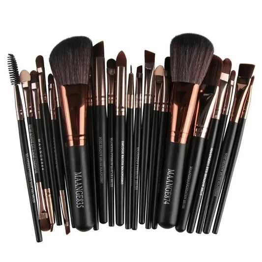 Set of makeup brushes with black handles and rose gold accents on a white background