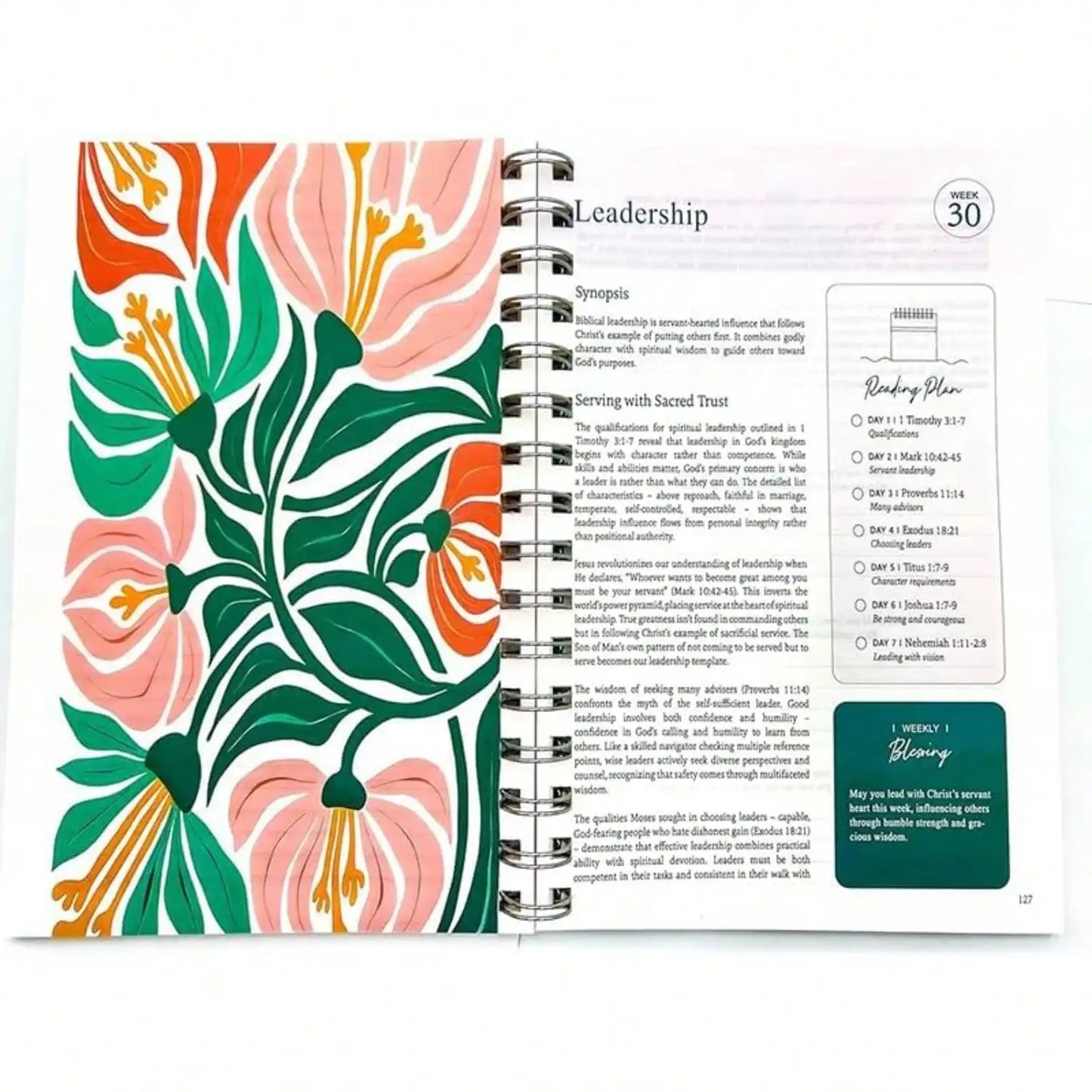 Spiral-bound planner with floral design on cover and text on pages