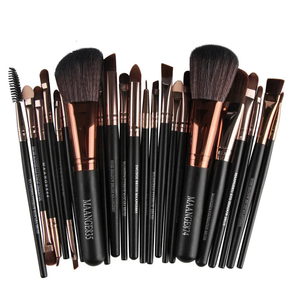 Set of makeup brushes with black and rose gold handles on a white background, branded 'MAANGE'.